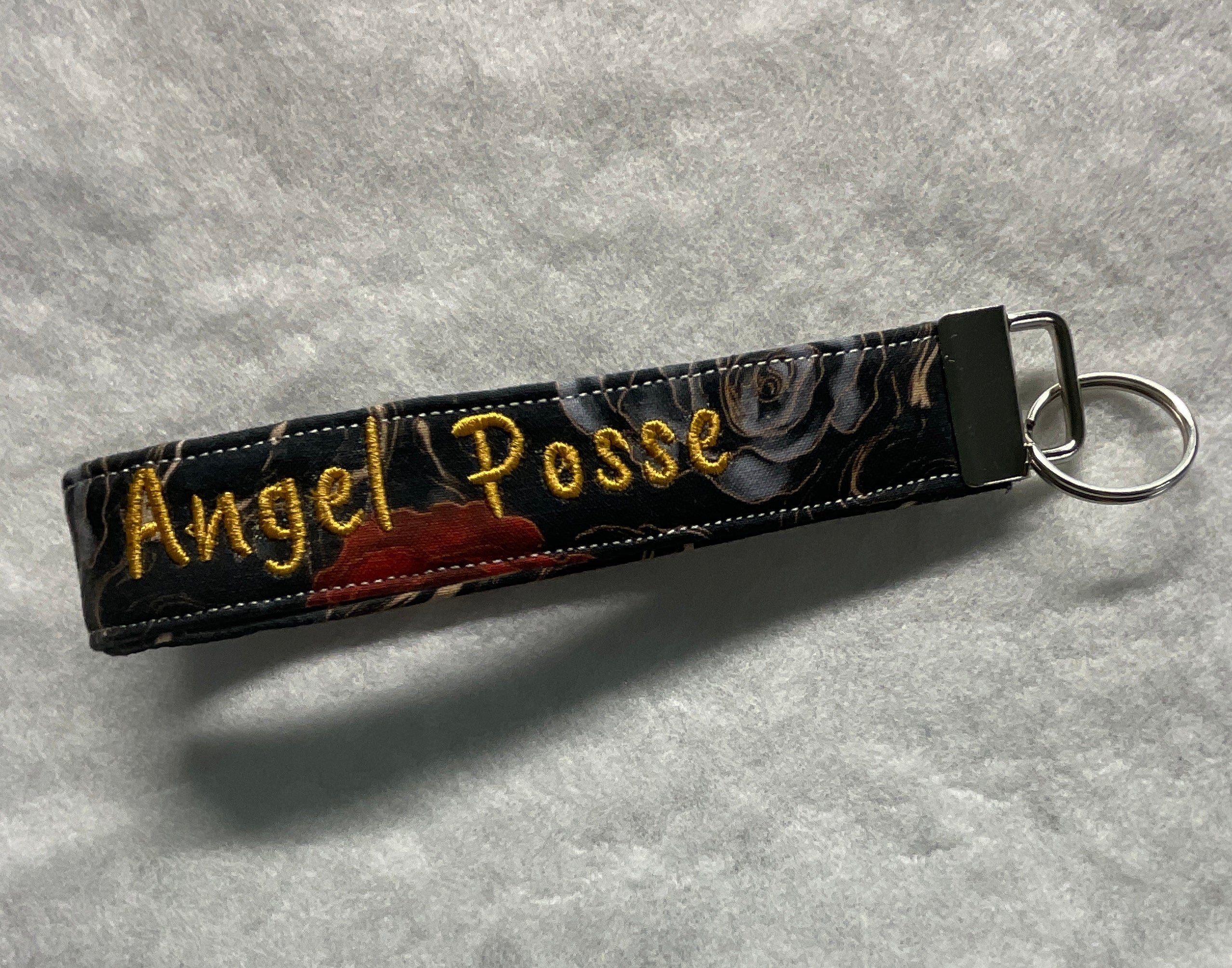 Keychain with 'Angel Posse' embroidery