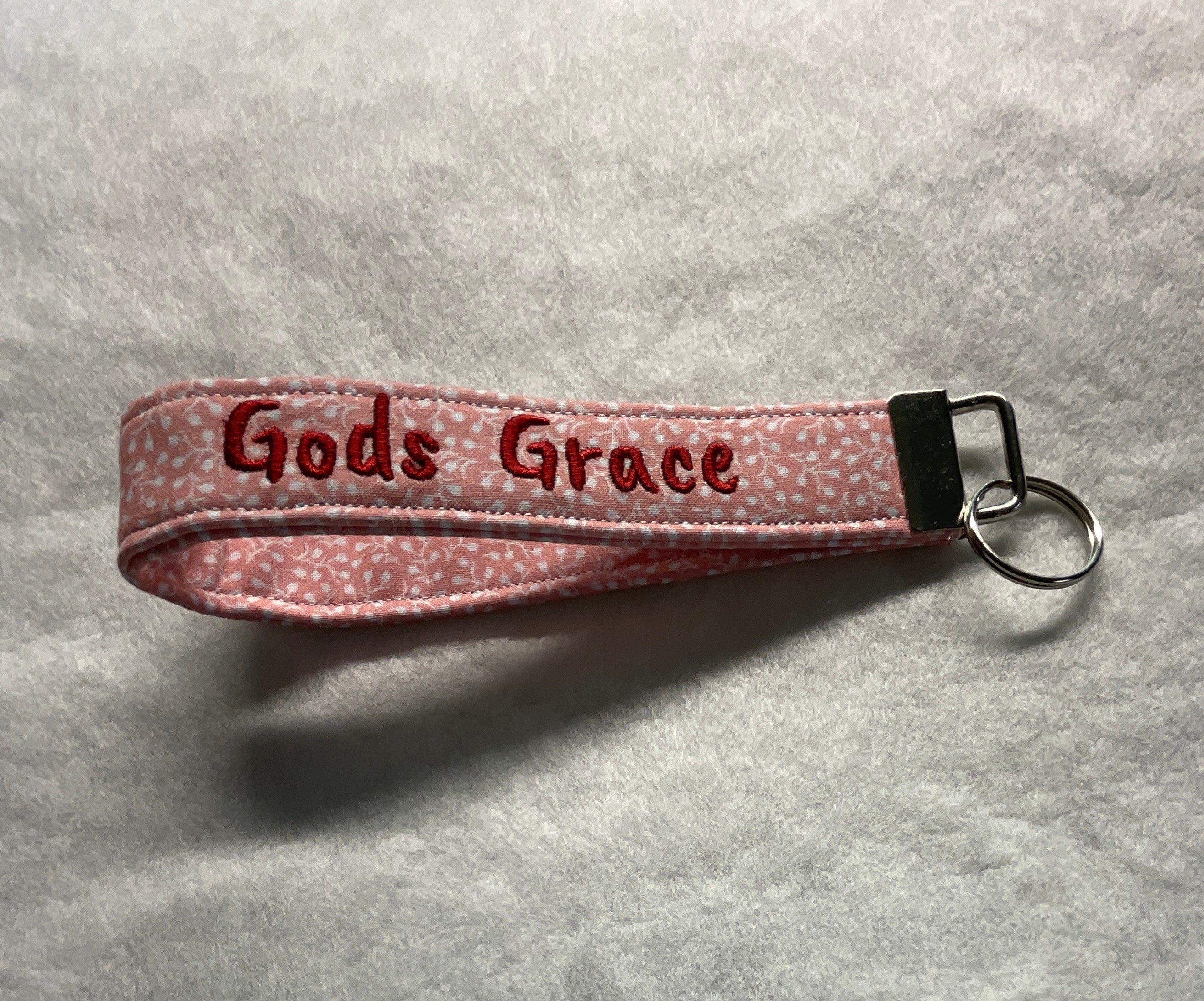 Pink keychain with 'Gods Grace' embroidery